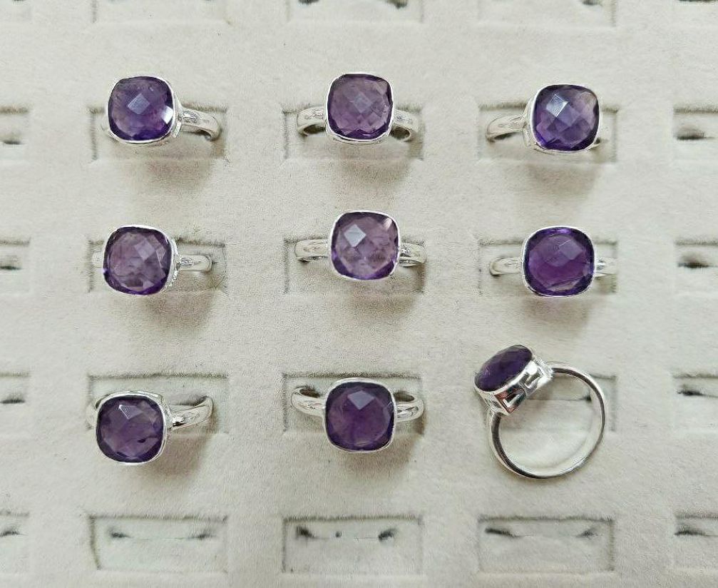 Wholesale lot of 9 Amethyst Cushion (10mm) rings in 925 Sterling Silver. (Ring Sizes- 6,7,8,9)