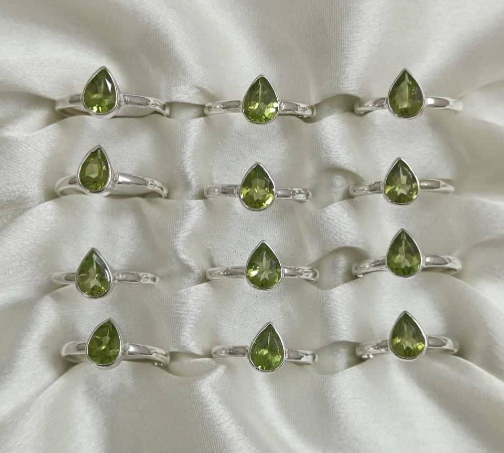 Wholesale lot of 12 Peridot pear shaped rings in 925 Sterling Silver.(Ring Sizes- 7-9 )